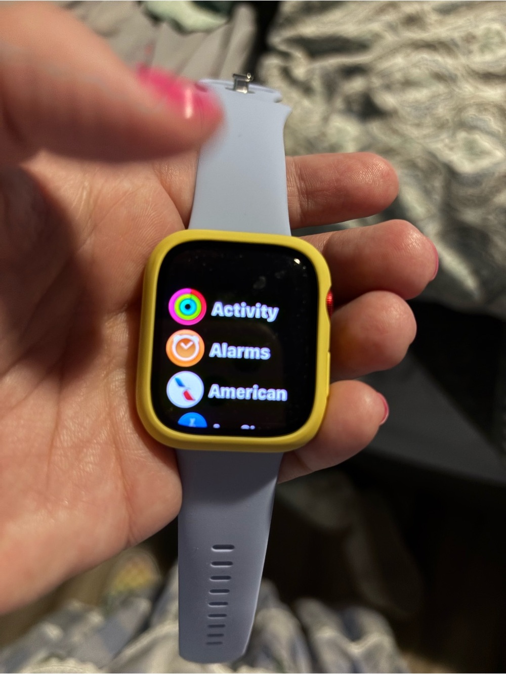 Apple Smartwatch with bag of watch covers and bands and charger.
